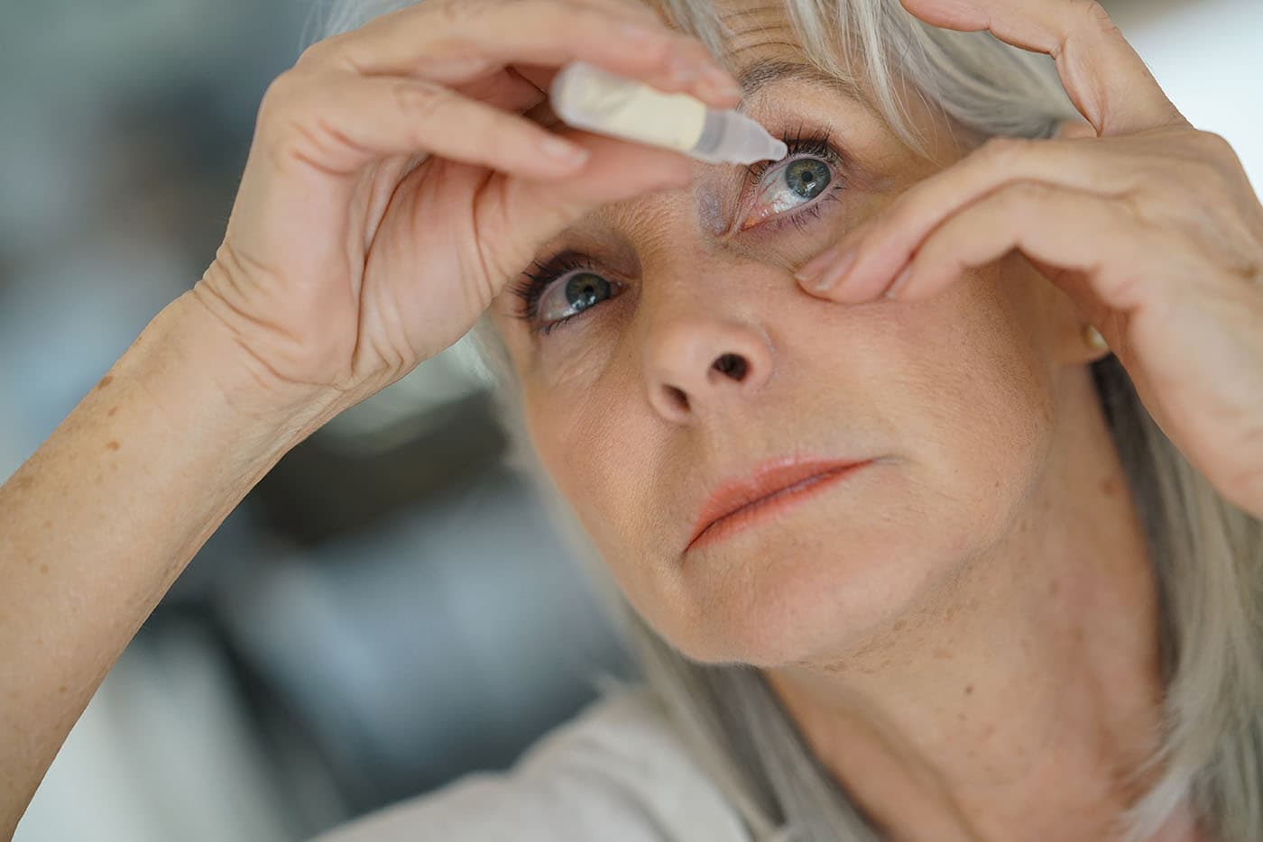 woman placing contact lenses in her eyes