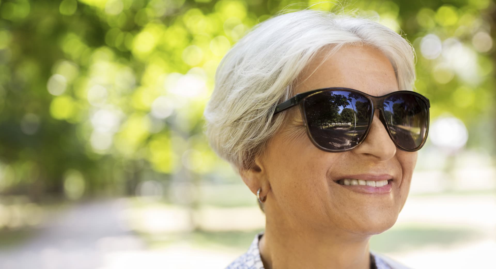 woman smiling with her sunglasses on